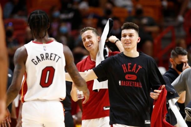 Tyler Herro of the Miami Heat high-fives teammates during a preseason game against the Atlanta Hawks on October 4, 2021 at FTX Arena in Miami,...