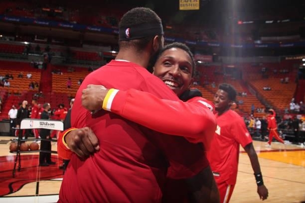 Lou Williams of the Atlanta Hawks hugs Markieff Morris of the Miami Heat before a preseason game on October 4, 2021 at FTX Arena in Miami, Florida....