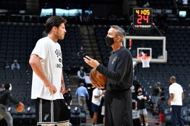 Doug McDermott talks with Assistant Coach, Chip Engelland of the San Antonio Spurs before a pre-season game against the Utah Jazz on October 4, 2021...