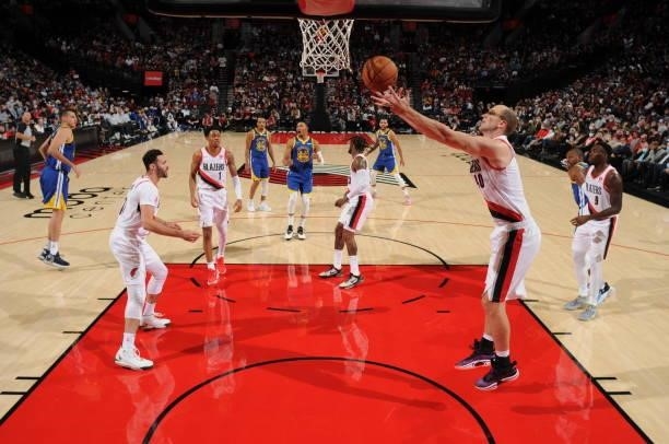 Cody Zeller of the Portland Trail Blazers rebounds the ball during a preseason game against the Golden State Warriors on October 4, 2021 at the Moda...