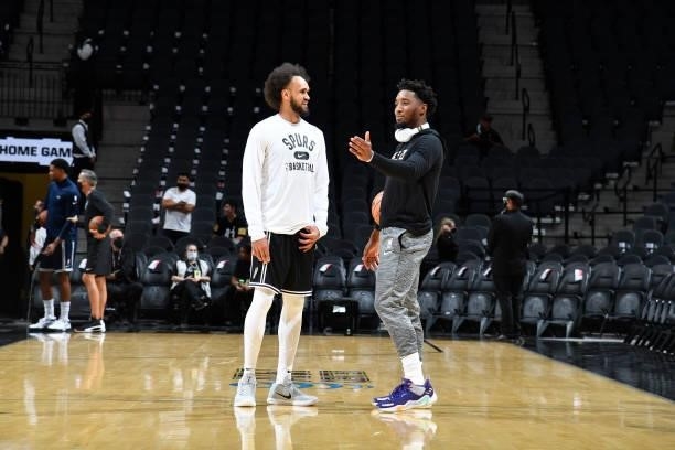 Derrick White of the San Antonio Spurs and Donovan Mitchell of the Utah Jazz talk before a pre-season game on October 4, 2021 at the AT&T Center in...
