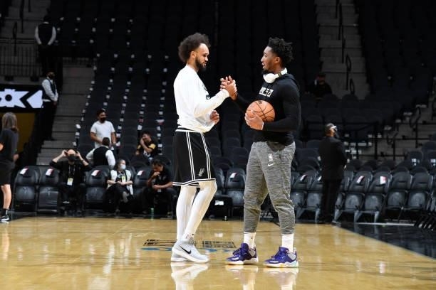 Derrick White of the San Antonio Spurs and Donovan Mitchell of the Utah Jazz sake hands before a pre-season game on October 4, 2021 at the AT&T...