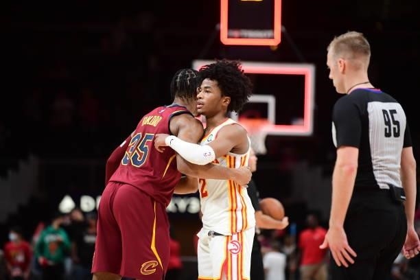Isaac Okoro of the Cleveland Cavaliers and Sharife Cooper of the Atlanta Hawks hug after a preseason game on October 6, 2021 at State Farm Arena in...
