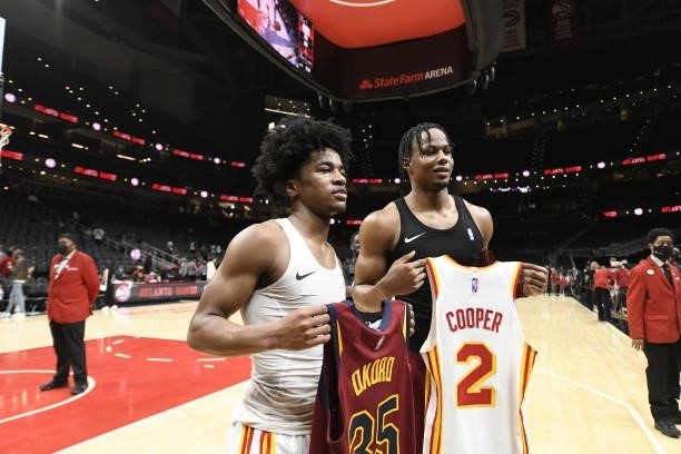 Isaac Okoro of the Cleveland Cavaliers and Sharife Cooper of the Atlanta Hawks swap jerseys after a preseason game on October 6, 2021 at State Farm...