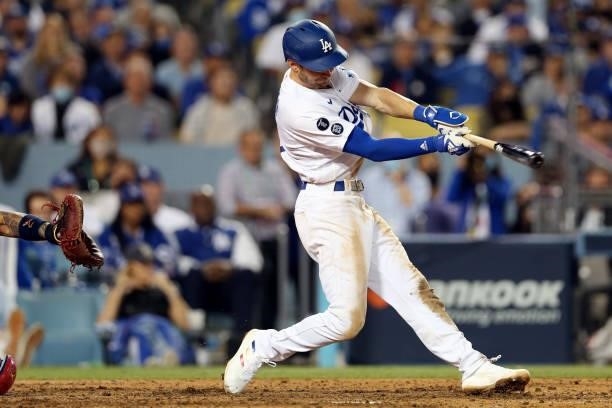 Trea Turner of the Los Angeles Dodgers hits a single in the bottom of the eighth inning during the game between the St. Louis Cardinals and the Los...