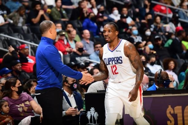 Eric Bledsoe of the LA Clippers high fives his coach during the game against the Sacramento Kings during a preseason game on October 6, 2021 at...