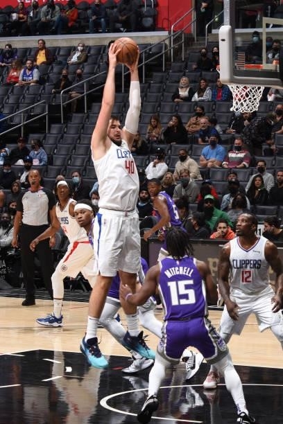 Ivica Zubac of the LA Clippers grabs the rebound against the Sacramento Kings during a preseason game on October 6, 2021 at STAPLES Center in Los...