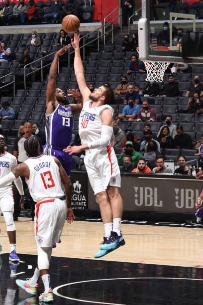 Ivica Zubac of the LA Clippers tips the ball against the Sacramento Kings during a preseason game on October 6, 2021 at STAPLES Center in Los...