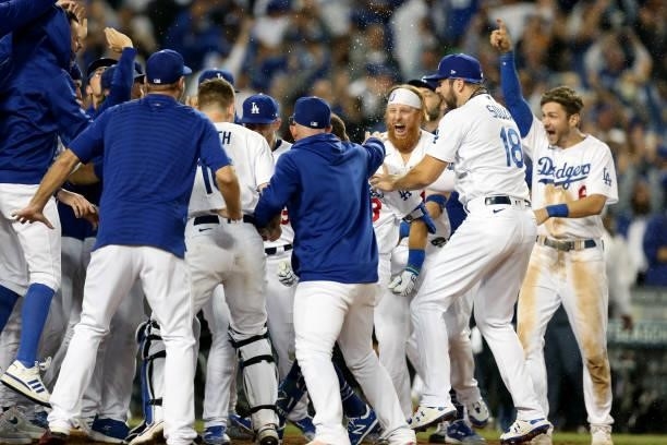 Members of the Los Angeles Dodgers celebrate after Chris Taylor hit a two-run home run in the bottom of the ninth inning as the Dodgers defeat the...