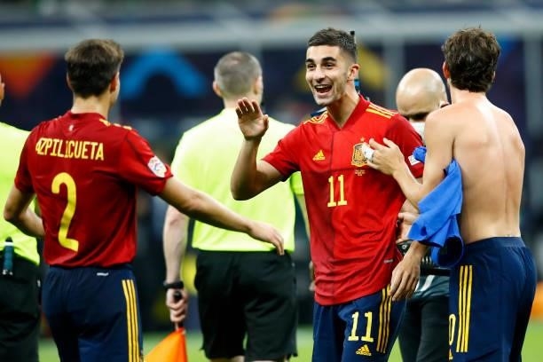 Ferran Torres of Spain and Cesar Azpilicueta of Spain celebrate after winning the UEFA Nations League Semi-Final match between the Italy and Spain at...