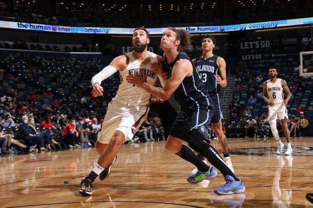 Jonas Valanciunas of the New Orleans Pelicans and Robin Lopez of the Orlando Magic fight for position during a preseason game on October 6, 2021 at...