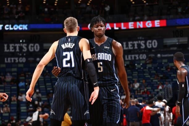 Mo Bamba of the Orlando Magic hugs his teammate during the game against the New Orleans Pelicans during a preseason game on October 6, 2021 at the...