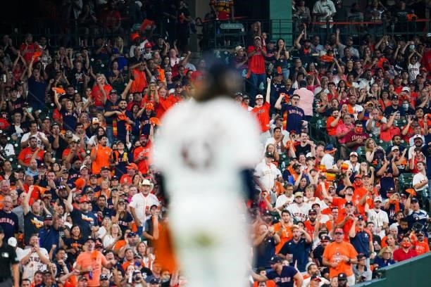 Fans cheer during an inning break during Game 1 of the ALDS between the Chicago White Sox and the Houston Astros at Minute Maid Park on Thursday,...
