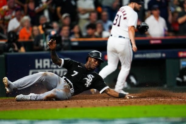 Tim Anderson of the Chicago White Sox slides into home off a Jose Abreu single during Game 1 of the ALDS between the Chicago White Sox and the...