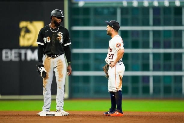 Luis Robert of the Chicago White Sox talks with Jose Altuve of the Houston Astros during Game 1 of the ALDS at Minute Maid Park on Thursday, October...