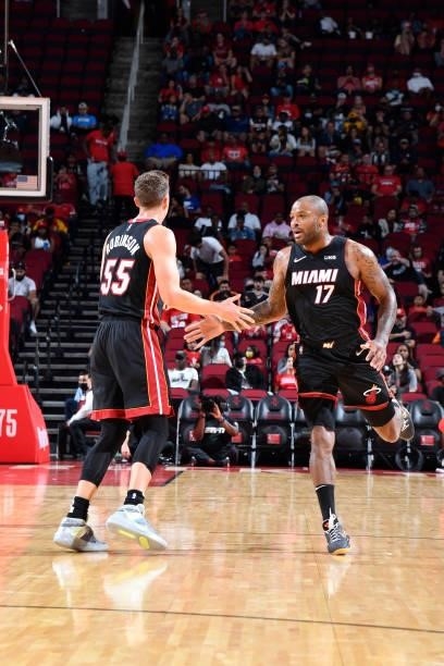 Tucker of the Miami Heat high-fives teammate Duncan Robinson during a preseason game against the Houston Rockets on October 7, 2021 at the Toyota...