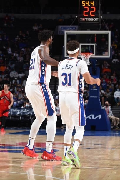 Joel Embiid of the Philadelphia 76ers and Seth Curry of the Philadelphia 76ers high-five during a preseason game on October 7, 2021 at Wells Fargo...
