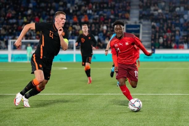 Felix Mambimbi of Switzerland battles for the ball with Sven Botman of Netherlands during the 2021 UEFA European Under-21 Championship Qualifier...