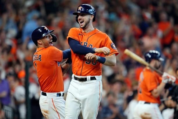 Kyle Tucker of the Houston Astros is greeted by teammate Carlos Correa after hitting a two-run home run in the seventh inning during Game 2 of the...