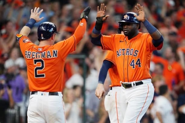 Yordan Alvarez of the Houston Astros is greeted by teammate Alex Bregman after scoring a run in the seventh inning during Game 2 of the ALDS between...