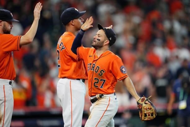 Jose Altuve of the Houston Astros celebrates with teammates after the Astros defeated the Chicago White Sox in Game 2 of the ALDS at Minute Maid Park...