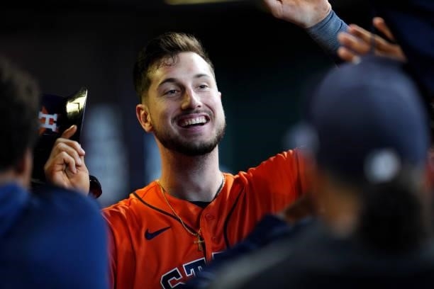 Kyle Tucker of the Houston Astros is greeted in the dugout after hitting a two-run home run in the seventh inning during Game 2 of the ALDS between...