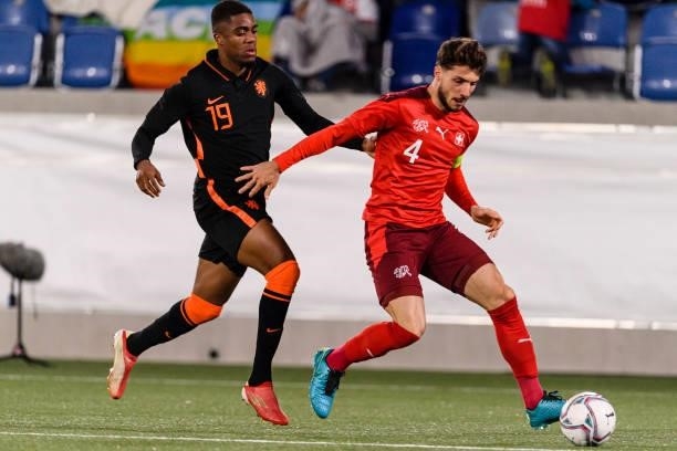Leonidas Stergiou of Switzerland is chased by Myron Boadu of Netherlands during the UEFA European Under-21 Qualifiers match between Switzerland and...