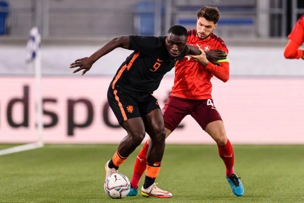 Leonidas Stergiou of Switzerland fights for the ball with Brian Brobbey of Netherlands during the UEFA European Under-21 Qualifiers match between...