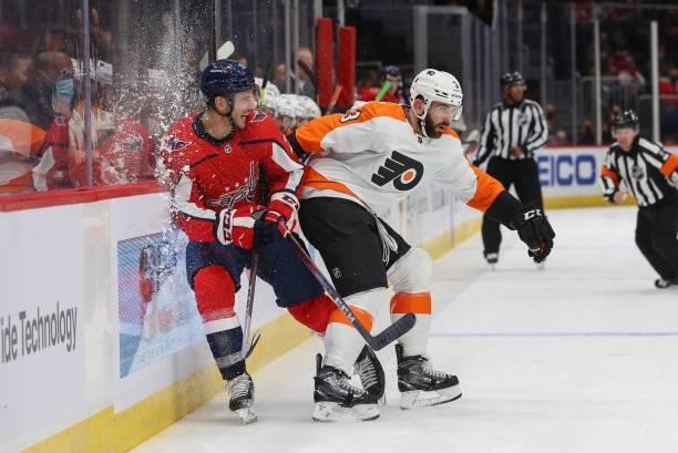 Washington Capitals right wing Garnet Hathaway gets hit by Philadelphia Flyers defenseman Keith Yandle during a game between the Philadelphia Flyers...