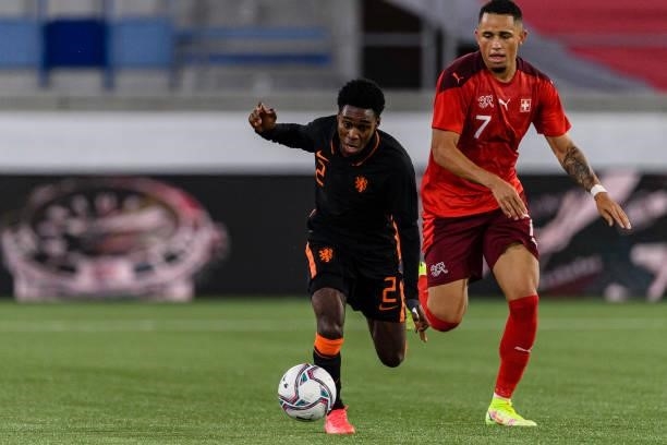 Jeremie Frimpong of Netherlands is chased by Noah Okafor of Switzerland during the UEFA European Under-21 Qualifiers match between Switzerland and...