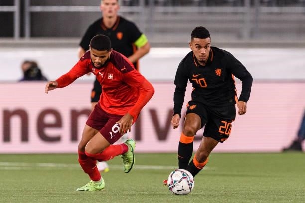 Daniel Van Kaam of Netherlands is chased by Simon Sohm of Switzerland during the UEFA European Under-21 Qualifiers match between Switzerland and...