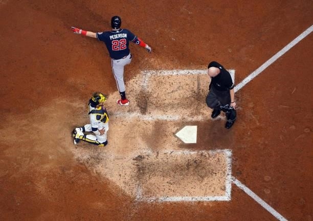 Joc Pederson of the Atlanta Braves crosses the plate after hitting a solo home run in the eighth inning of Game 1 of the NLDS between the Atlanta...