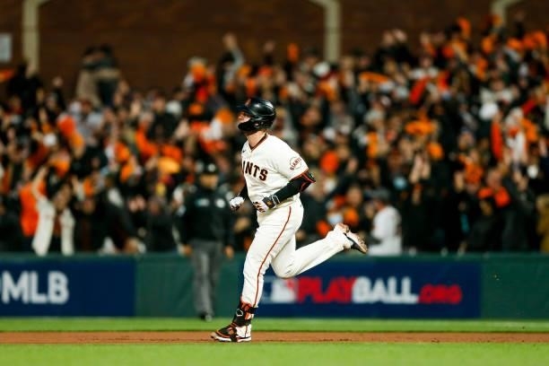 Buster Posey of the San Francisco Giants runs the bases after hitting a solo home run in the first inning of Game 1 of the NLDS between the Los...