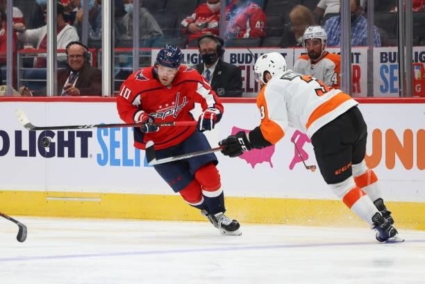 Washington Capitals right wing Daniel Sprong flips up the puck to get around Philadelphia Flyers defenseman Keith Yandle during a game between the...