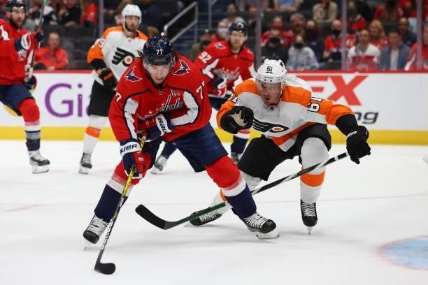 Washington Capitals right wing T.J. Oshie looks to take a shot on net as Philadelphia Flyers defenseman Justin Braun is in pursuit during a game...