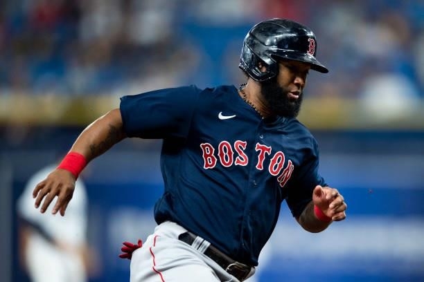 Danny Santana of the Boston Red Sox rounds third base as he scores during the ninth inning of game two of the 2021 American League Division Series...