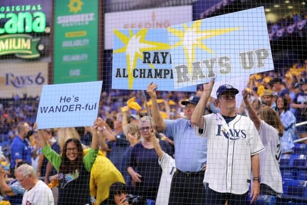Fans hold signs during Game 2 of the ALDS between the Boston Red Sox and the Tampa Bay Rays at Tropicana Field on Friday, October 8, 2021 in Tampa,...