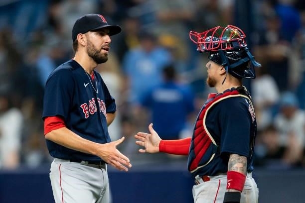 Matt Barnes and Christian Vazquez of the Boston Red Sox celebrate a victory in game two of the 2021 American League Division Series against the Tampa...