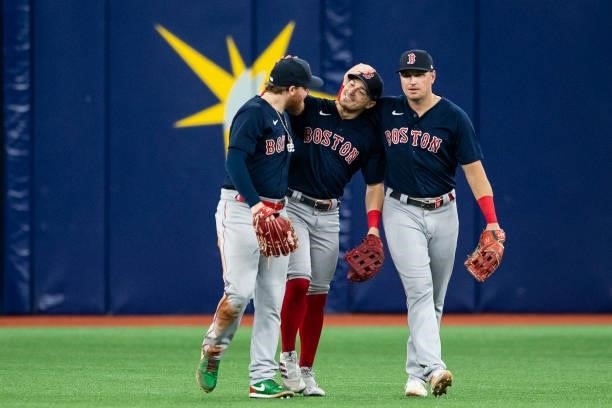 Alex Verdugo, Enrique Hernandez, and Hunter Renfroe of the Boston Red Sox celebrate a victory in game two of the 2021 American League Division Series...