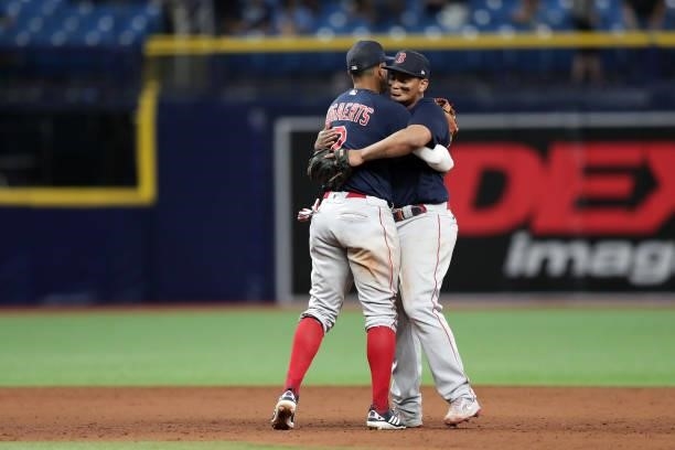 Xander Bogaerts and Rafael Devers of the Boston Red Sox celebrate after a 14-6 win in Game 2 of the ALDS between the Boston Red Sox and the Tampa Bay...