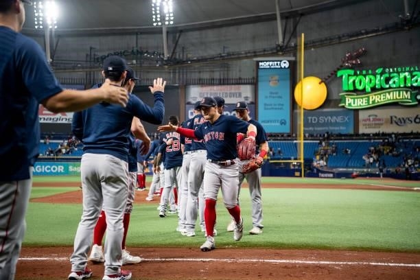 Enrique Hernandez of the Boston Red Sox high fives teammates after a victory in game two of the 2021 American League Division Series against the...