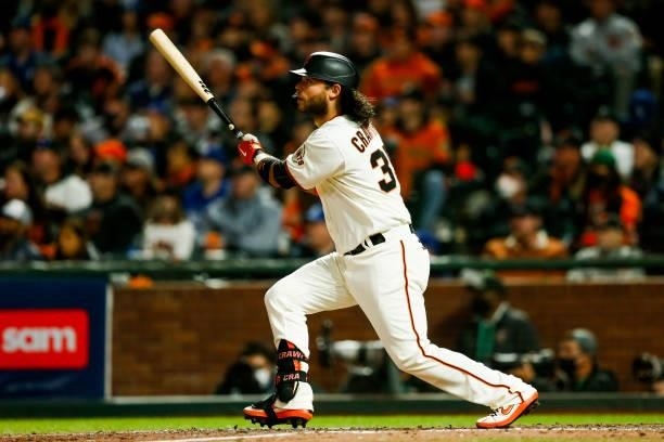 Brandon Crawford of the San Francisco Giants hits a solo home run in the eighth inning during Game 1 of the NLDS between the Los Angeles Dodgers and...