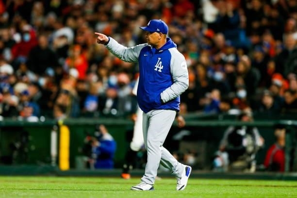 Dave Roberts of the Los Angeles Dodgers points to the dugout to indicate a pitching change during Game 1 of the NLDS between the Los Angeles Dodgers...