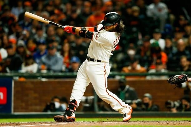 Brandon Crawford of the San Francisco Giants hits a solo home run in the eighth inning during Game 1 of the NLDS between the Los Angeles Dodgers and...
