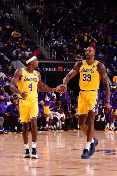 Rajon Rondo of the Los Angeles Lakers high fives Dwight Howard of the Los Angeles Lakers during a preseason game against the Golden State Warriors on...