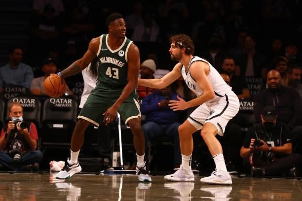 Thanasis Antetokounmpo of the Milwaukee Bucks in action against Joe Harris of the Brooklyn Nets at Barclays Center on October 08, 2021 in New York...