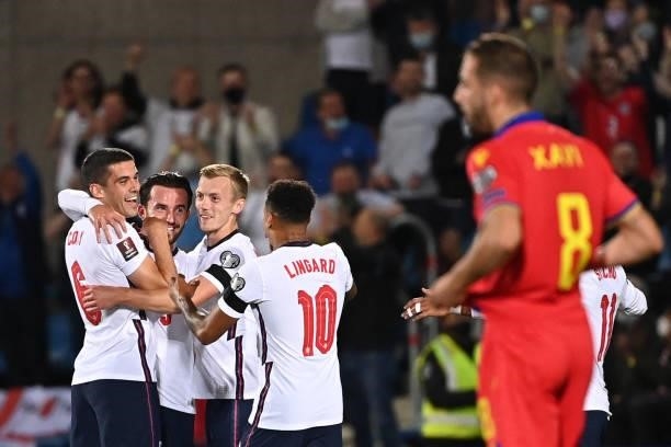 England's defender Ben Chilwell is congratulated by teammates after scoring a goal during the World Cup 2022 qualifier football match between Andorra...