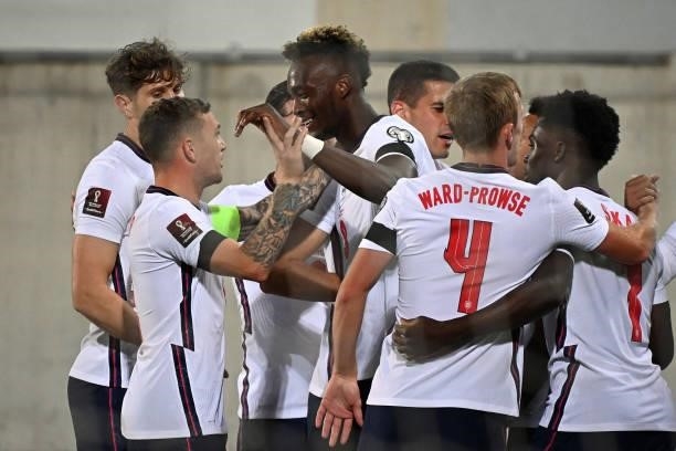 England's forward Tammy Abraham celebrates with teammates after scoring a goal during the World Cup 2022 qualifier football match between Andorra and...
