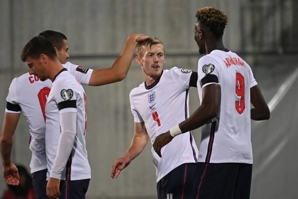 England's midfielder James Ward-Prowse is congratulated by teammates after scoring a goal during the World Cup 2022 qualifier football match between...
