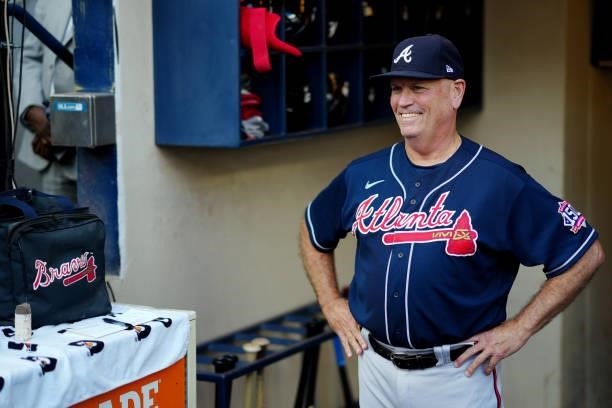 Brian Snitker of the Atlanta Braves looks on from the dugout prior to Game 2 of the NLDS between the Atlanta Braves and the Milwaukee Brewers at...